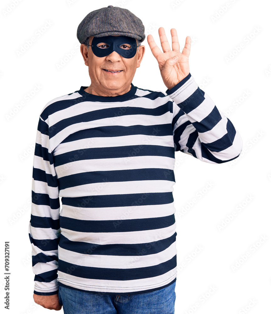 Senior handsome man wearing burglar mask and t-shirt showing and pointing up with fingers number four while smiling confident and happy.