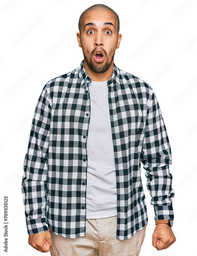 Hispanic adult man wearing casual clothes afraid and shocked with surprise expression, fear and excited face. Hispanic adult man wearing casual clothes afraid and shocked with surprise expression, fear and excited face.