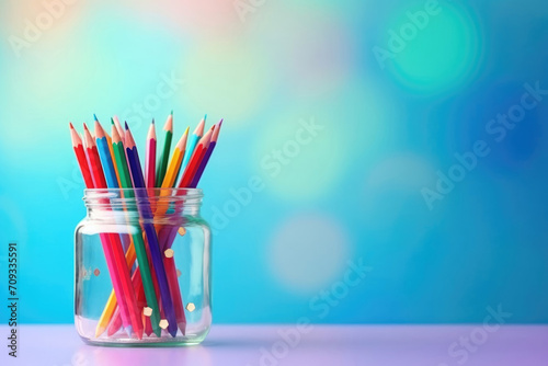 glass jar with colored pencils, stationery, teachers day, return to school, place for text photo