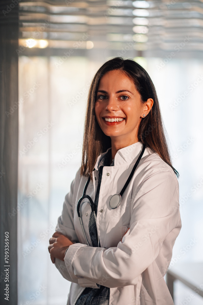 Portrait of a smiling female doctor posing while looking into the camera Portrait of a smiling female doctor posing while looking into the camera