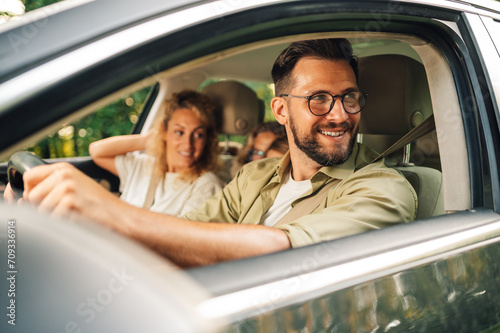 Portrait of a father driving a car to spend a weekend with his family