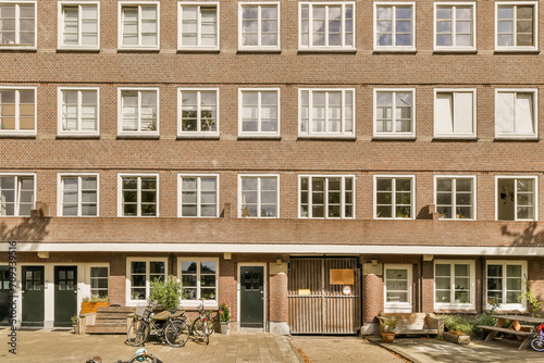 Traditional brick apartment building with bicycles photo