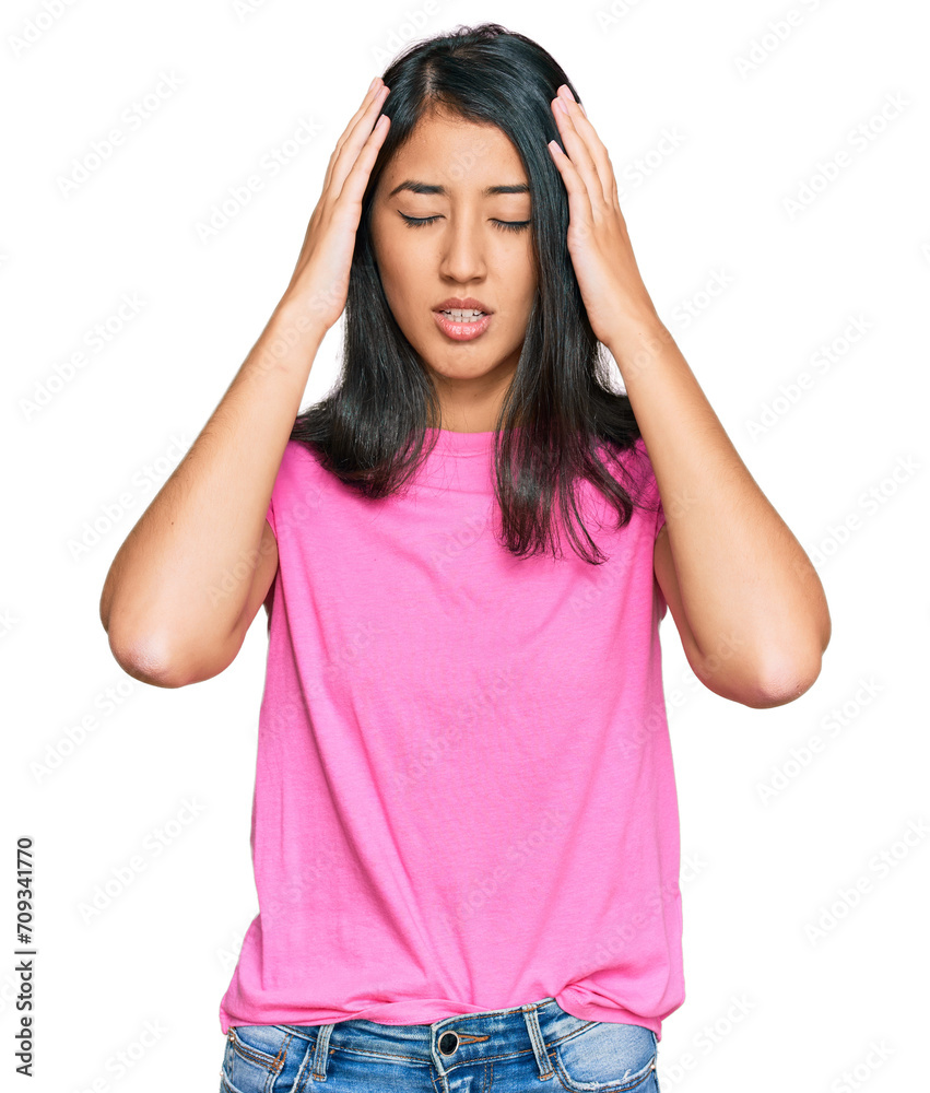 Beautiful asian young woman wearing casual pink t shirt suffering from headache desperate and stressed because pain and migraine. hands on head. Beautiful asian young woman wearing casual pink t shirt suffering from headache desperate and stressed because pain and migraine. hands on head.