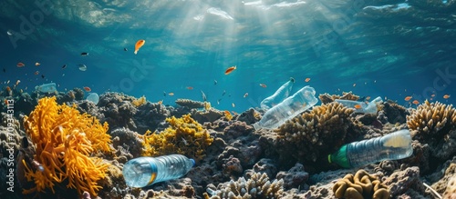 Ocean pollution caused by bottles, bags, and cans on coral reef.