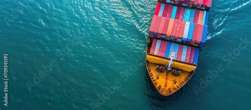 Container ship departing port, seen from above.