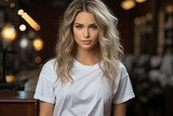 Lovely young woman with blond hair in white t-shit looking at the camera