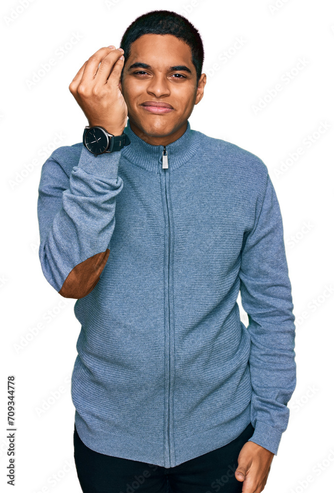Fototapeta premium Young handsome hispanic man wearing casual sweatshirt doing italian gesture with hand and fingers confident expression