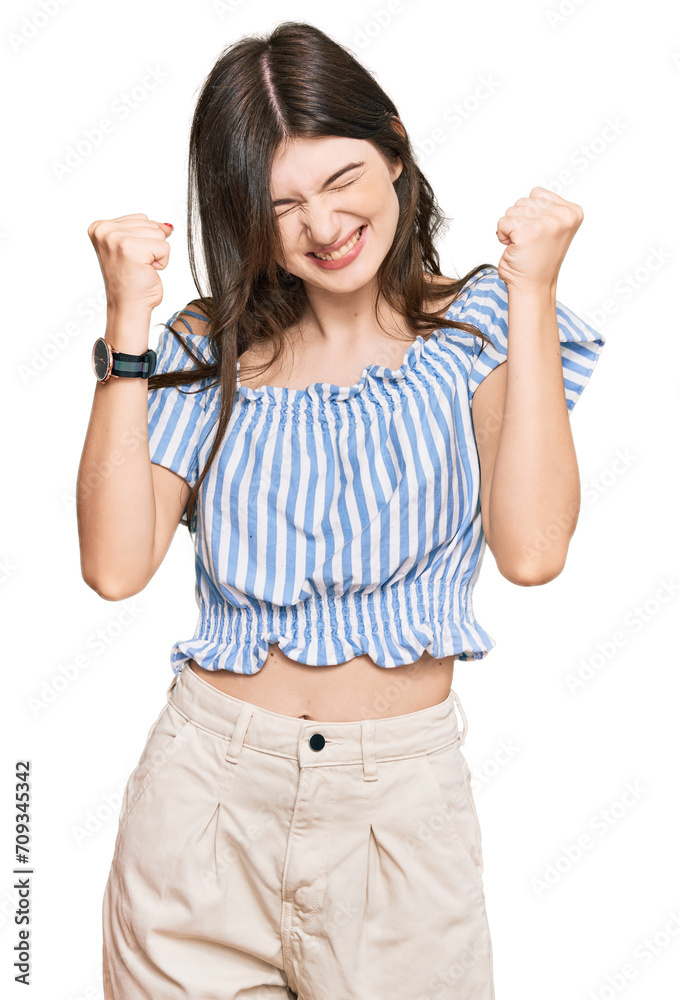 Young beautiful caucasian girl wearing casual clothes excited for success with arms raised and eyes closed celebrating victory smiling. winner concept. Young beautiful caucasian girl wearing casual clothes excited for success with arms raised and eyes closed celebrating victory smiling. winner concept.