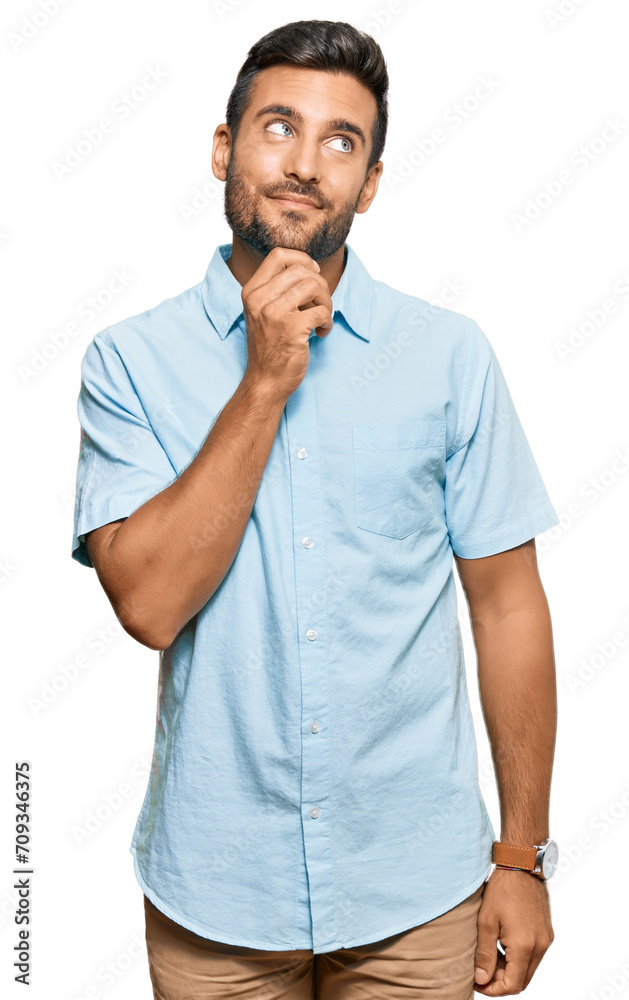 Fototapeta premium Handsome hispanic man wearing casual clothes with hand on chin thinking about question, pensive expression. smiling with thoughtful face. doubt concept.
