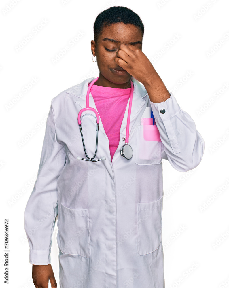 Young african american woman wearing doctor uniform and stethoscope tired rubbing nose and eyes feeling fatigue and headache. stress and frustration concept. Young african american woman wearing doctor uniform and stethoscope tired rubbing nose and eyes feeling fatigue and headache. stress and frustration concept.