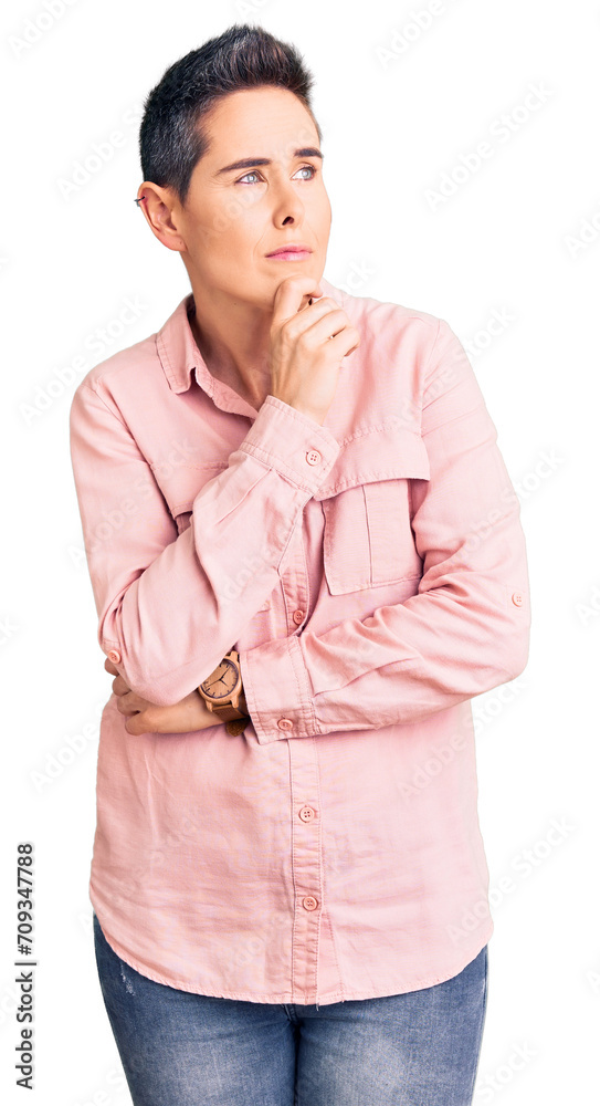 Young woman with short hair wearing casual clothes with hand on chin thinking about question, pensive expression. smiling with thoughtful face. doubt concept. Young woman with short hair wearing casual clothes with hand on chin thinking about question, pensive expression. smiling with thoughtful face. doubt concept.