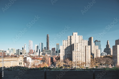 View of modern tall buildings and traditional apartment buildings seen from roof deck in Brooklyn, NY