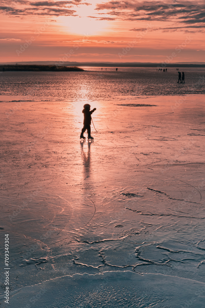 silhouette of a hokey player on a frozen lake