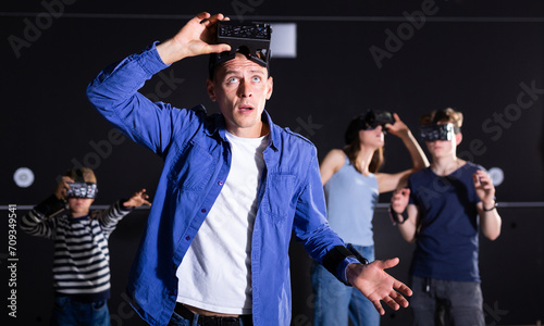 Принти на полотні Portrait of a surprised young male who has taken off his virtual reality glasses and does not understand what is