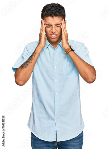 Young handsome african american man wearing casual clothes with hand on head, headache because stress. suffering migraine.