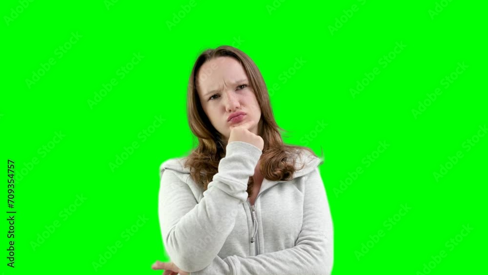 thinking girl put hand to chin and does not understand the situation thinks rolled her eyes upward pouting her lips on a white background teenager in the studio. incomprehensible situation thinking girl put hand to chin and does not understand the situation thinks rolled her eyes upward pouting her lips on a white background teenager in the studio. incomprehensible situation