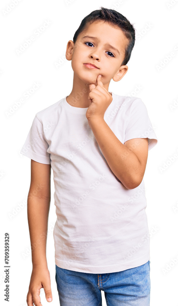 Little cute boy kid wearing casual white tshirt serious face thinking about question with hand on chin, thoughtful about confusing idea Little cute boy kid wearing casual white tshirt serious face thinking about question with hand on chin, thoughtful about confusing idea