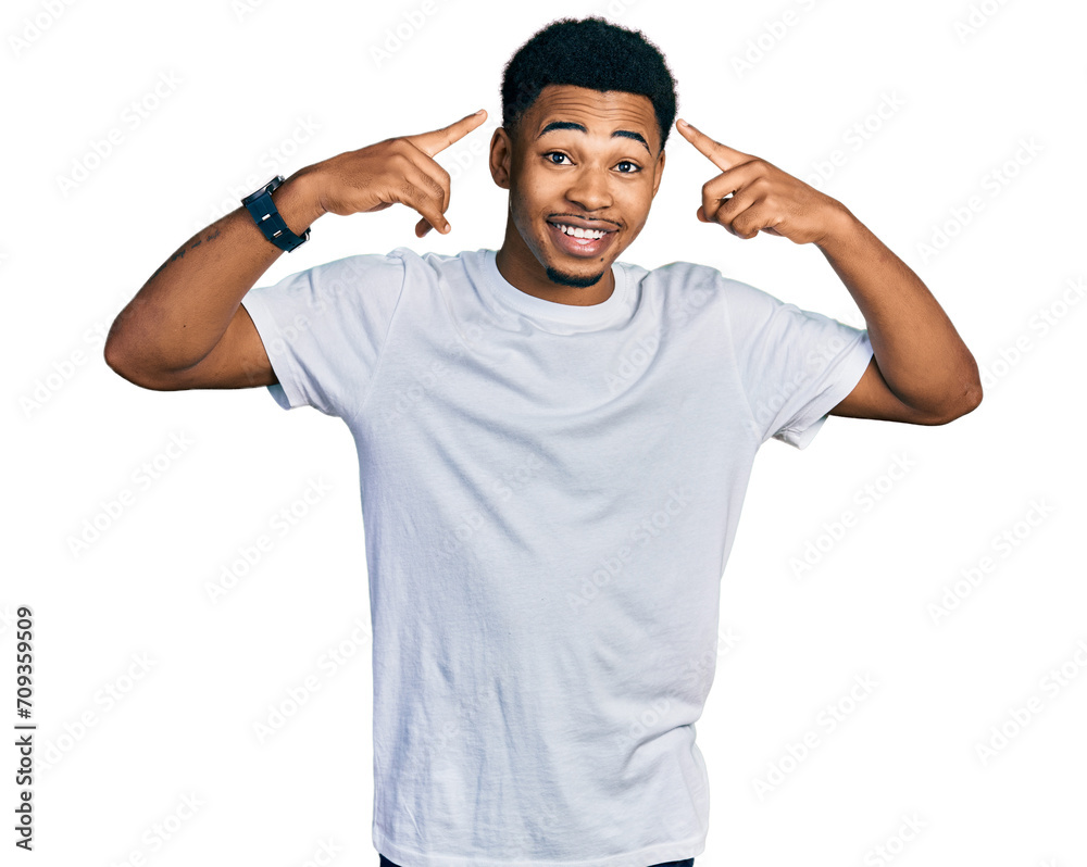 Young african american man wearing casual white t shirt smiling pointing to head with both hands finger, great idea or thought, good memory Young african american man wearing casual white t shirt smiling pointing to head with both hands finger, great idea or thought, good memory