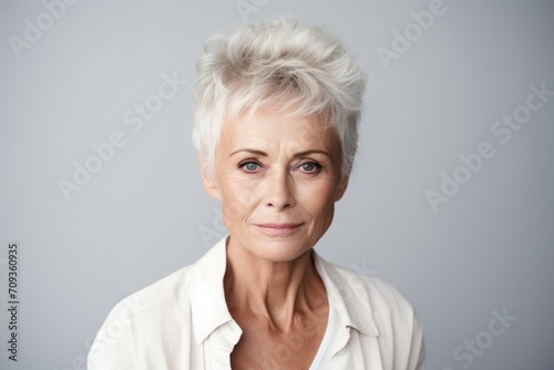 Portrait of an attractive mature woman with short white hair looking at camera
