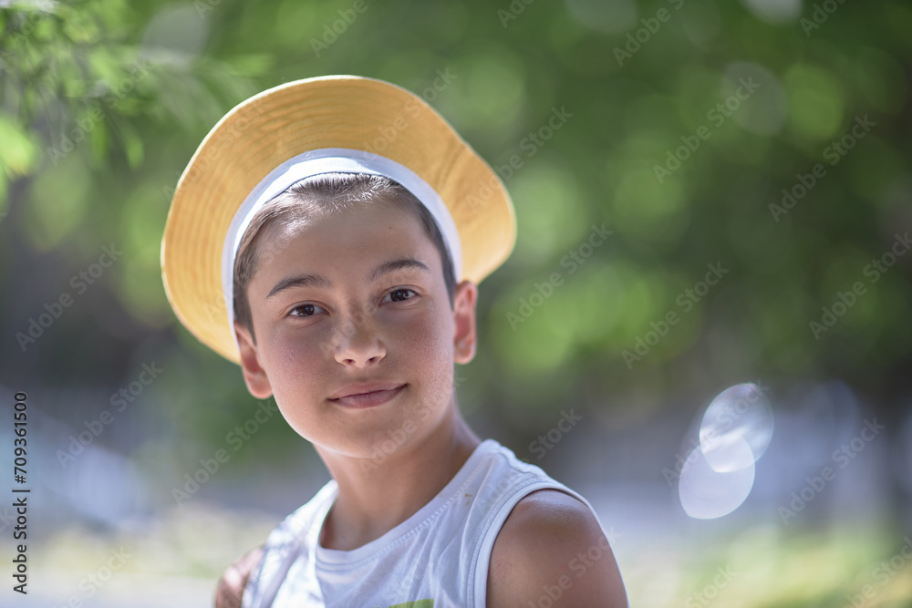 portrait of a child, a dark-haired boy of 10 years old in a summer cafe. Drinks a mojito and eats a hamburger