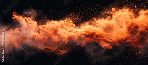 Fire particles impacting dust and debris, set against a black backdrop, create a swirling burst of powdery spray.