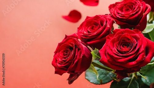 flying petals and red roses on a red background with copy space creative floral levitation in ther nature layout spring blossom concept for wedding women mother 8 march valentine s day
