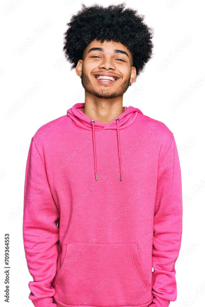 Young african american man with afro hair wearing casual pink sweatshirt with a happy and cool smile on face. lucky person. Young african american man with afro hair wearing casual pink sweatshirt with a happy and cool smile on face. lucky person.