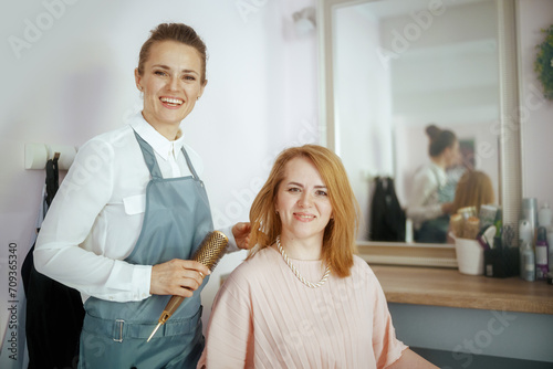 40 years old hair salon employee in modern beauty salon