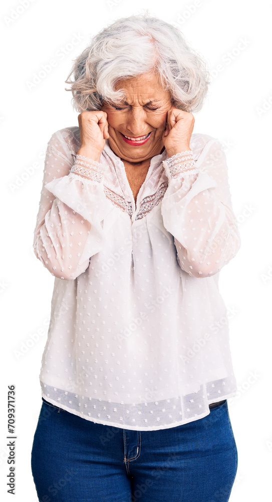 Senior grey-haired woman wearing casual clothes covering ears with fingers with annoyed expression for the noise of loud music. deaf concept. Senior grey-haired woman wearing casual clothes covering ears with fingers with annoyed expression for the noise of loud music. deaf concept.