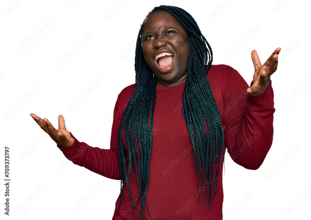 Φωτογραφία Young black woman with braids wearing casual clothes crazy and mad shouting and yelling with aggressive expression and arms raised