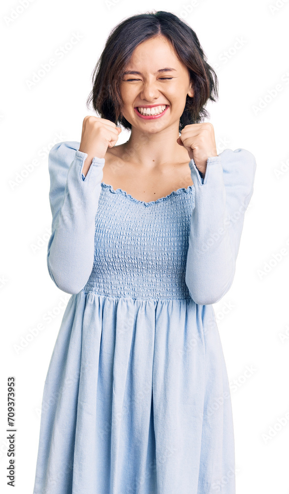 Young beautiful girl wearing casual clothes excited for success with arms raised and eyes closed celebrating victory smiling. winner concept. Young beautiful girl wearing casual clothes excited for success with arms raised and eyes closed celebrating victory smiling. winner concept.