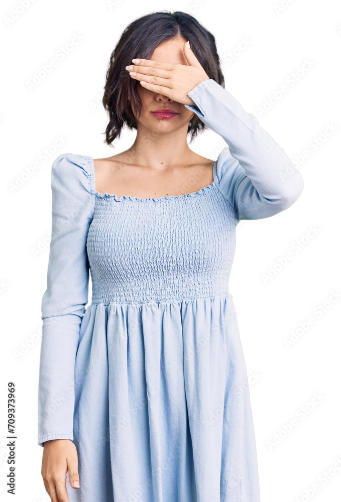 Young beautiful girl wearing casual clothes covering eyes with hand, looking serious and sad. sightless, hiding and rejection concept Young beautiful girl wearing casual clothes covering eyes with hand, looking serious and sad. sightless, hiding and rejection concept