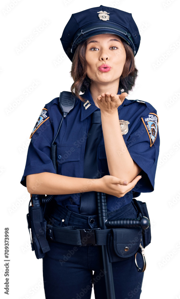 Young beautiful girl wearing police uniform looking at the camera blowing a kiss with hand on air being lovely and sexy. love expression. Young beautiful girl wearing police uniform looking at the camera blowing a kiss with hand on air being lovely and sexy. love expression.