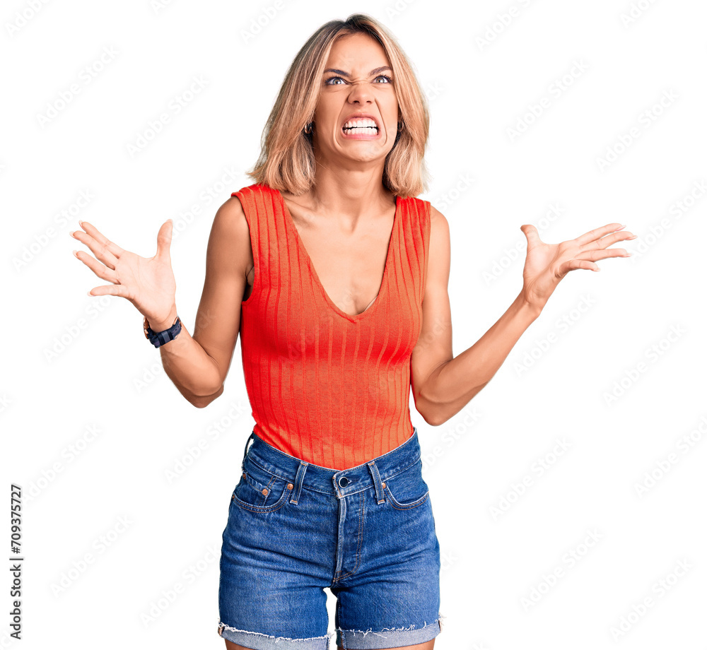 Beautiful caucasian woman wearing casual clothes crazy and mad shouting and yelling with aggressive expression and arms raised. frustration concept. Beautiful caucasian woman wearing casual clothes crazy and mad shouting and yelling with aggressive expression and arms raised. frustration concept.