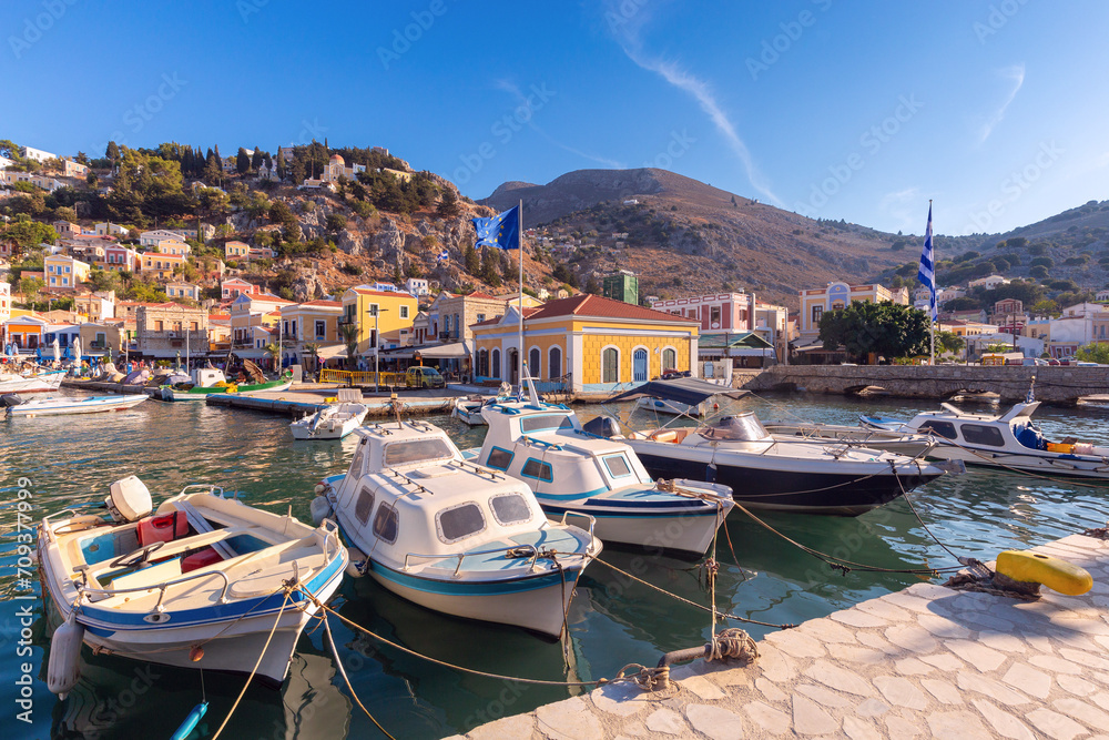 Obraz premium Multi-colored facades of houses in the village of Symi at sunset.