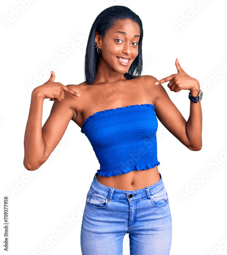 Young african american woman wearing casual summer clothes looking confident with smile on face, pointing oneself with fingers proud and happy. photo