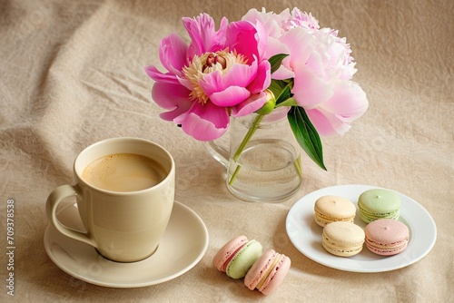 A cup of coffee and some macaroons on a table.