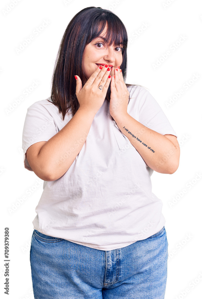 Young plus size woman wearing casual clothes laughing and embarrassed giggle covering mouth with hands, gossip and scandal concept Young plus size woman wearing casual clothes laughing and embarrassed giggle covering mouth with hands, gossip and scandal concept