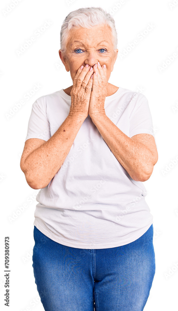 Senior beautiful woman with blue eyes and grey hair wearing casual white tshirt laughing and embarrassed giggle covering mouth with hands, gossip and scandal concept Senior beautiful woman with blue eyes and grey hair wearing casual white tshirt laughing and embarrassed giggle covering mouth with hands, gossip and scandal concept