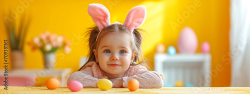 Beautiful child with bunny ears with chocolate eggs