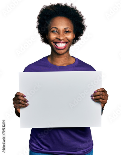 African american woman with afro hair holding blank empty banner smiling with a happy and cool smile on face. showing teeth.