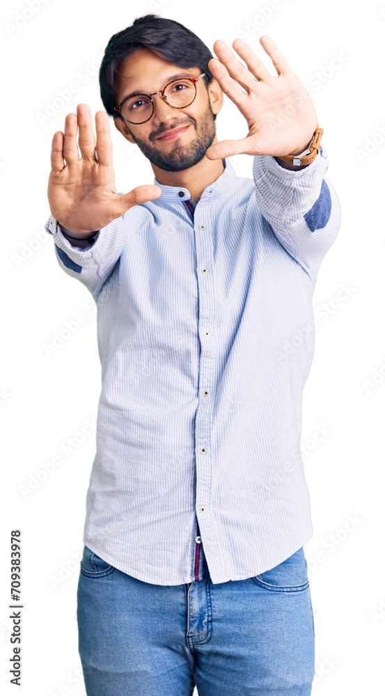 Handsome hispanic man wearing business shirt and glasses doing frame using hands palms and fingers, camera perspective Handsome hispanic man wearing business shirt and glasses doing frame using hands palms and fingers, camera perspective