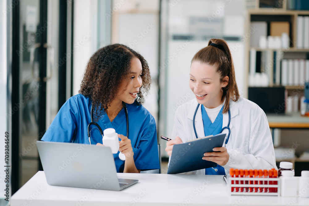 Doctor Talks With Professional Head Nurse or Surgeon, They Use Digital tablet Computer. Diverse Team of Health Care Specialists Discussing Test Result Doctor Talks With Professional Head Nurse or Surgeon, They Use Digital tablet Computer. Diverse Team of Health Care Specialists Discussing Test Result