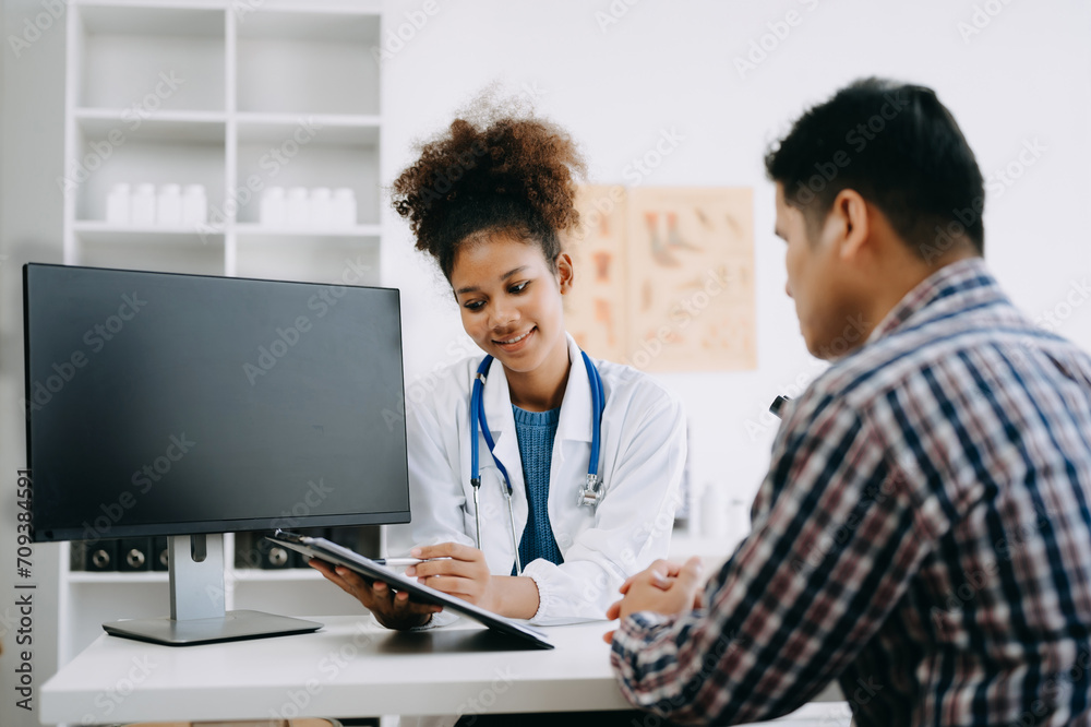 Doctor consulting with patient discussing something and Presenting results on report, Medicine and health care concept. Doctor consulting with patient discussing something and Presenting results on report, Medicine and health care concept.