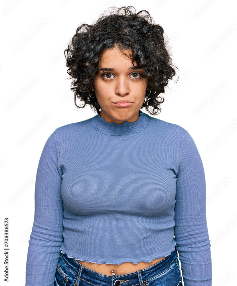 Young hispanic woman with curly hair wearing casual clothes depressed and worry for distress, crying angry and afraid. sad expression. Young hispanic woman with curly hair wearing casual clothes depressed and worry for distress, crying angry and afraid. sad expression.