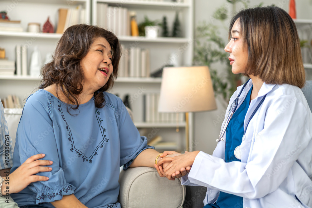 Fototapeta premium Portrait of smiling caring asian doctor service help support discussing and consulting taking care, caring, caregiver with senior elderly asian woman at home visit.senior retirement home care