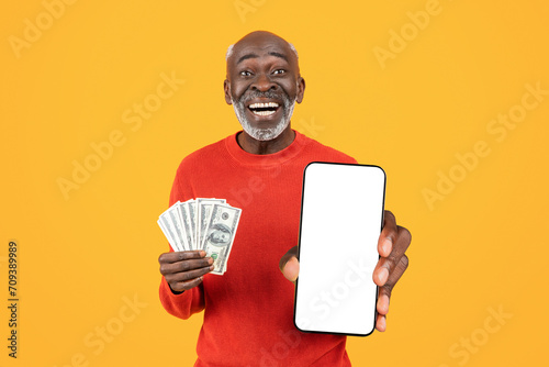 Glad old african american man show credit card and mobile phone with blank screen