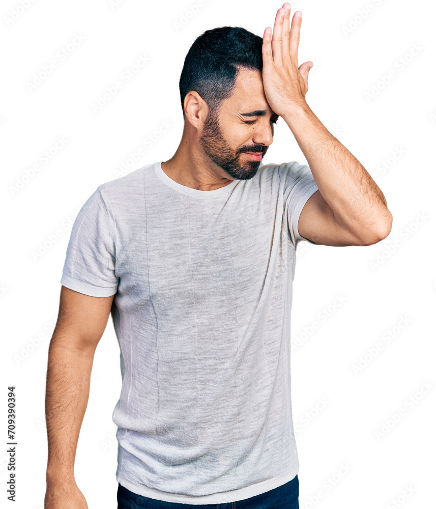 Young hispanic man with beard wearing casual grey t shirt surprised with hand on head for mistake, remember error. forgot, bad memory concept. Young hispanic man with beard wearing casual grey t shirt surprised with hand on head for mistake, remember error. forgot, bad memory concept.