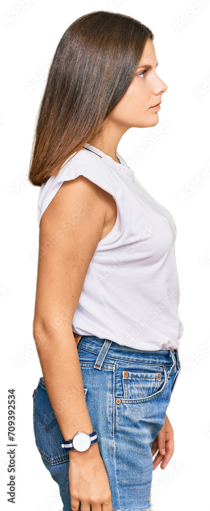 Young caucasian woman wearing casual white tshirt looking to side, relax profile pose with natural face with confident smile. Young caucasian woman wearing casual white tshirt looking to side, relax profile pose with natural face with confident smile.