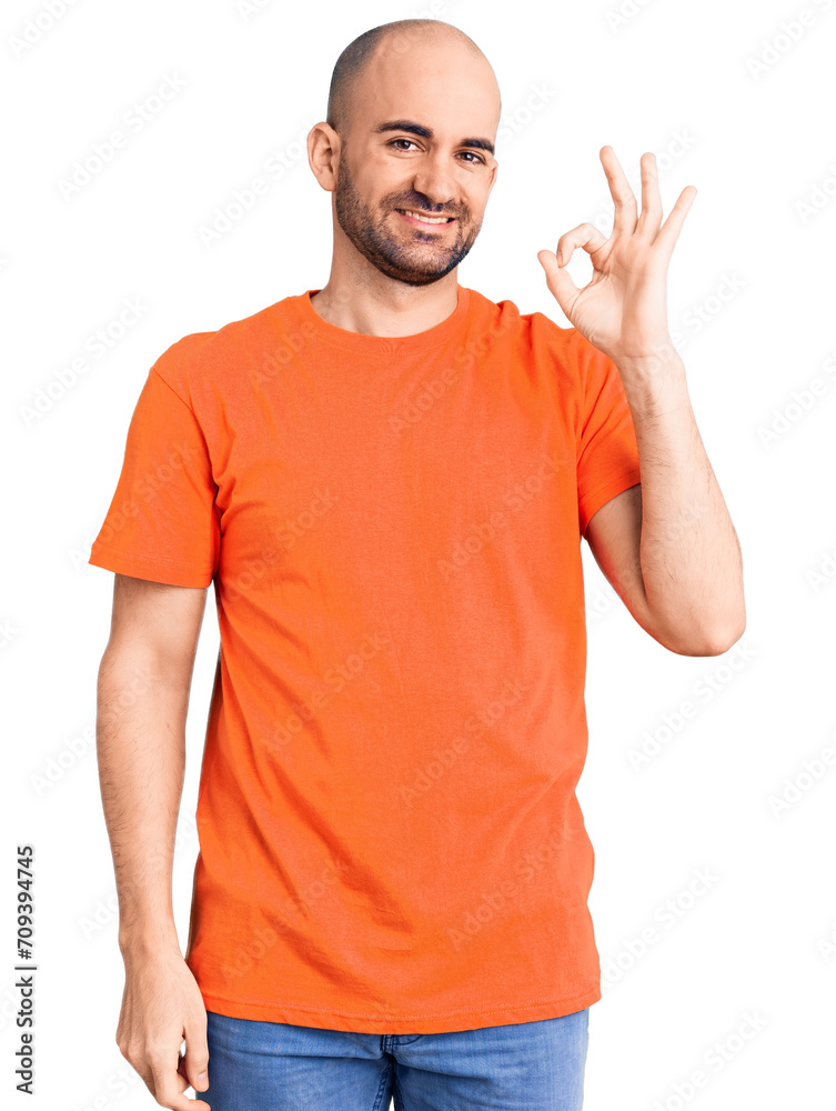 Young handsome man wering casual t shirt smiling positive doing ok sign with hand and fingers. successful expression. Young handsome man wering casual t shirt smiling positive doing ok sign with hand and fingers. successful expression.